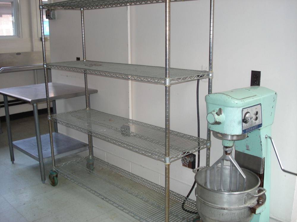 Metal shelves and food mixer in Greentop kitchen.