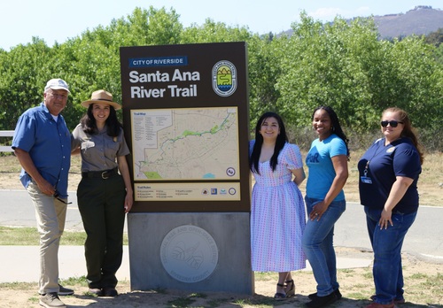 A map with title Santa Ana River Trail with two people standing to the left and three to the right.