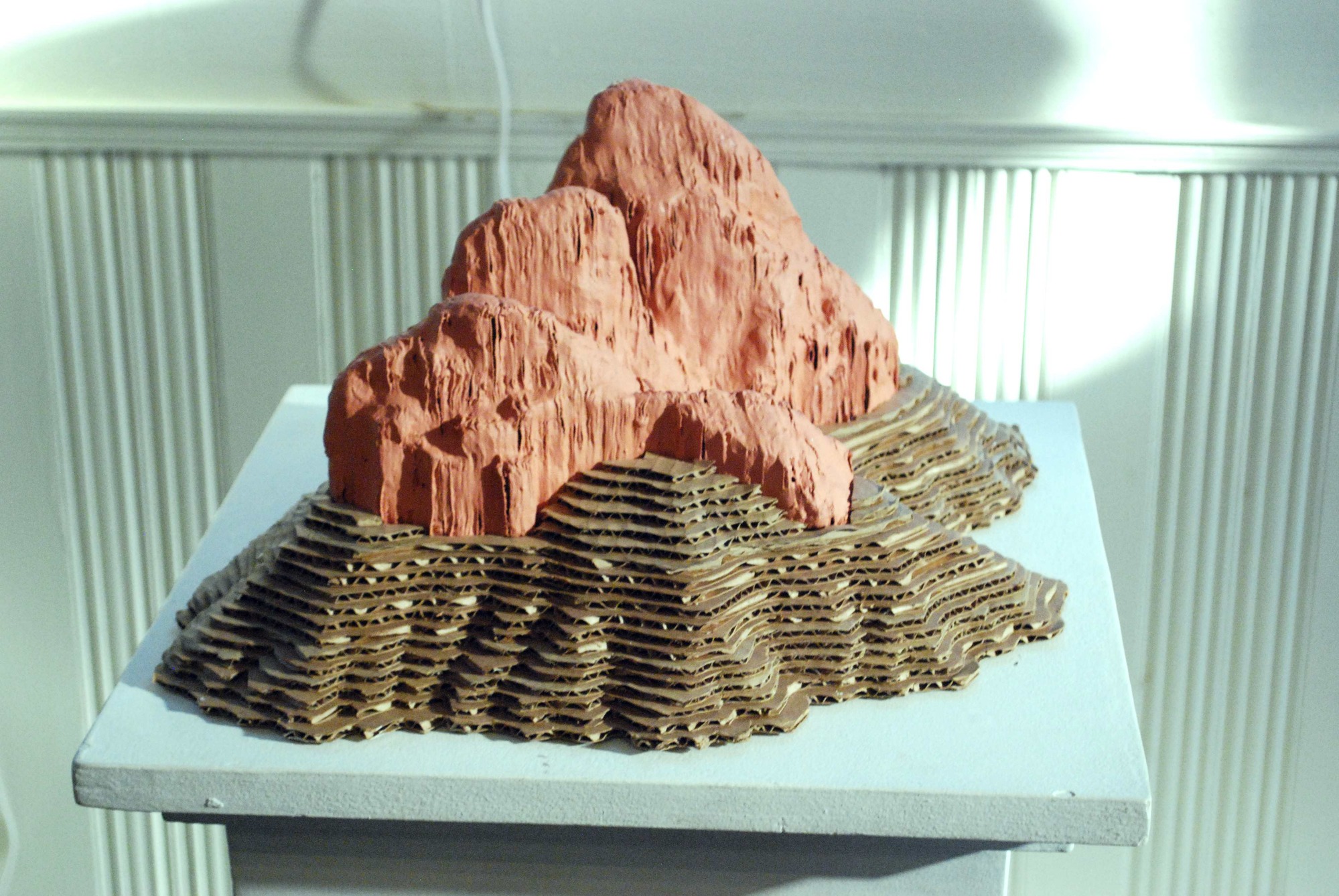 painted cardboard layers make a mountain with built in topographic lines. 