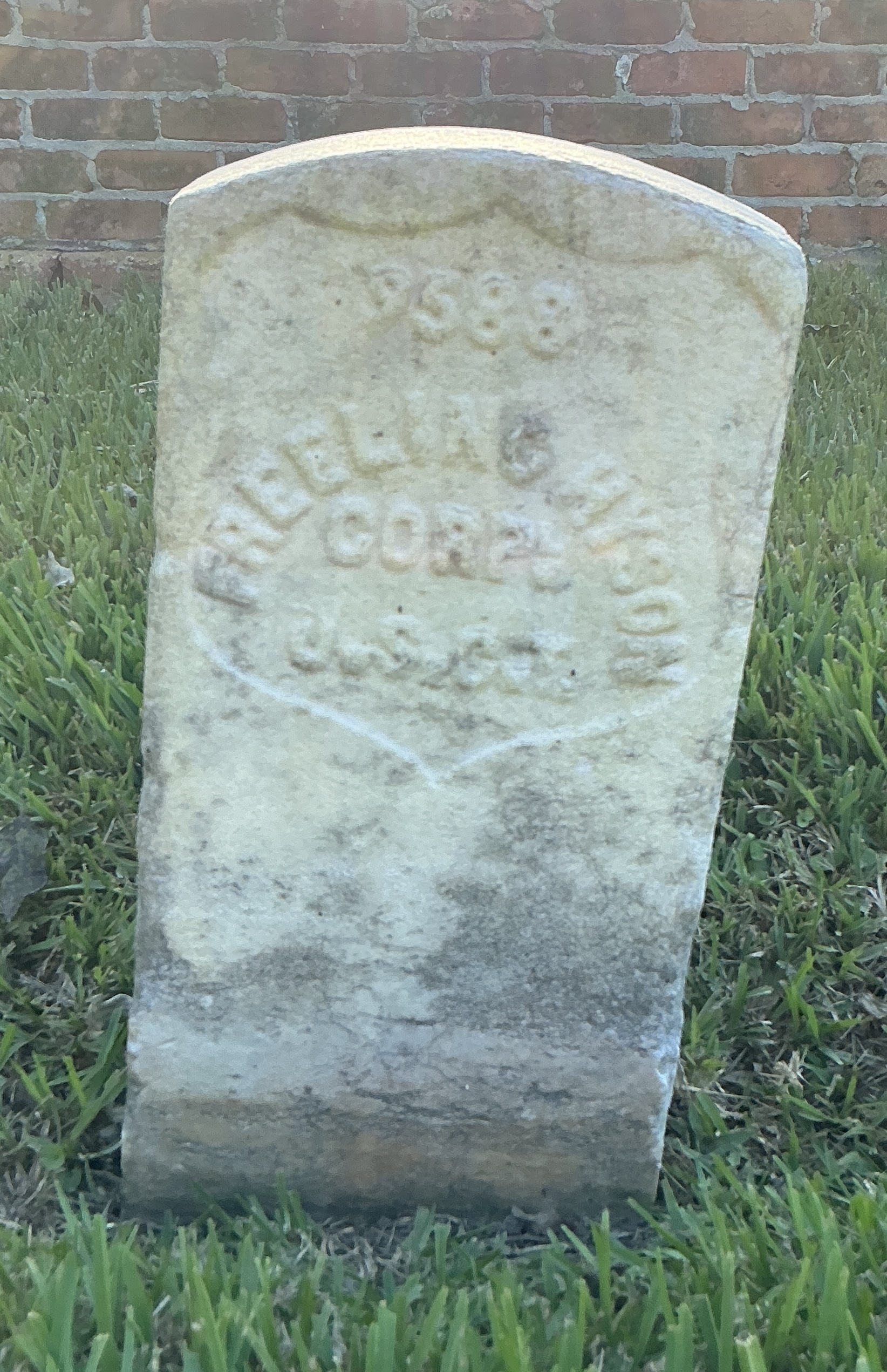 Front of historic upright marble headstone with recessed shield face.