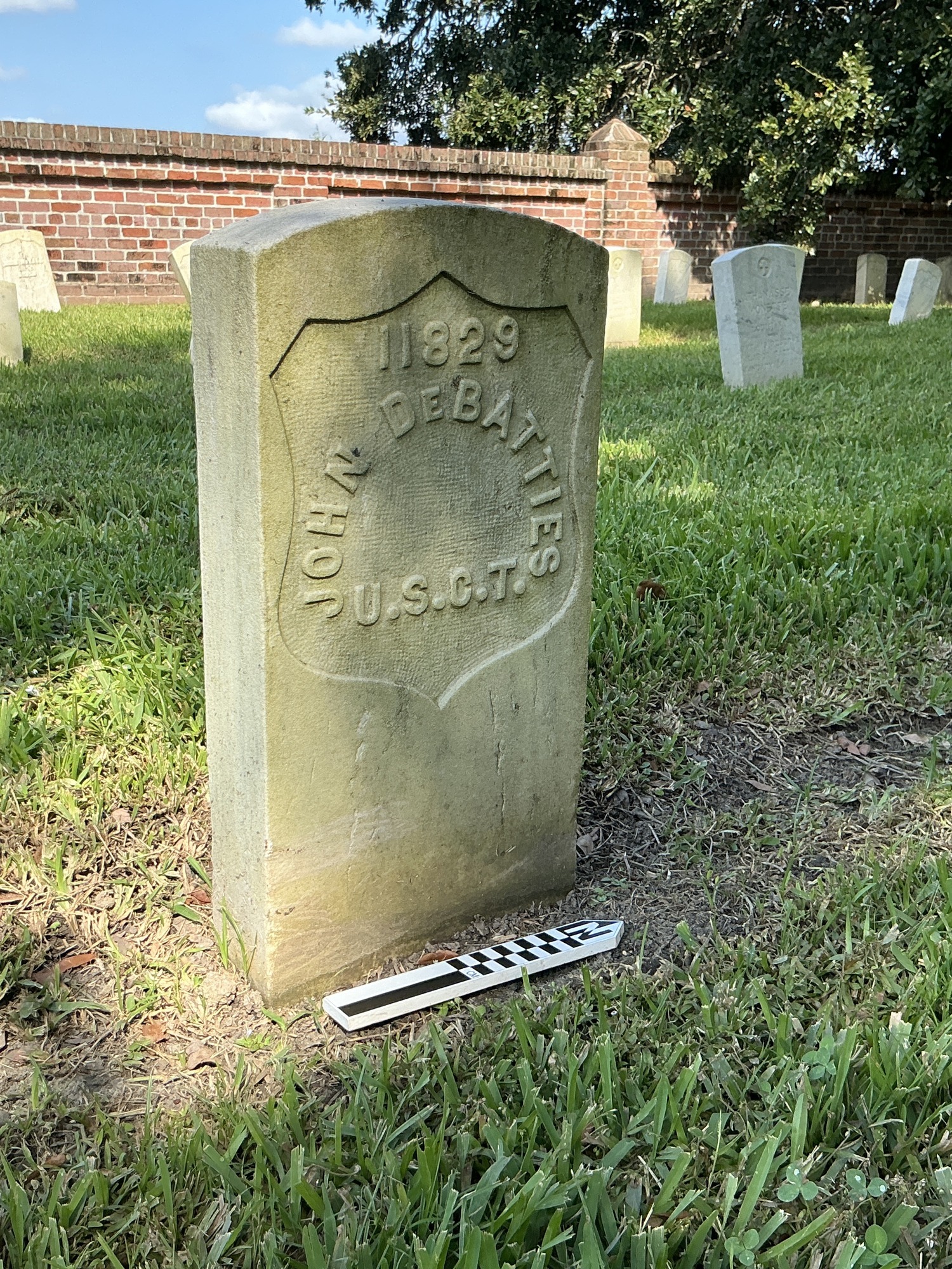 Extra image of historic upright marble headstone with recessed shield face.