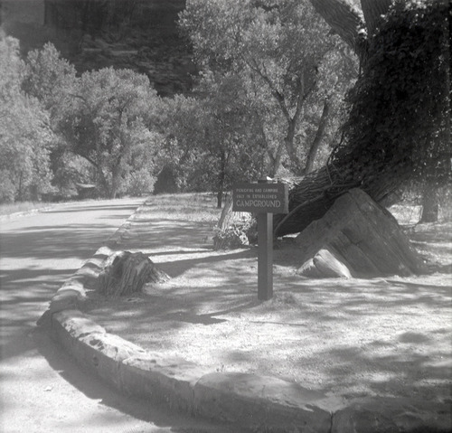 Sign stating 'Picnicking and camping only in established campground' near the Grotto.