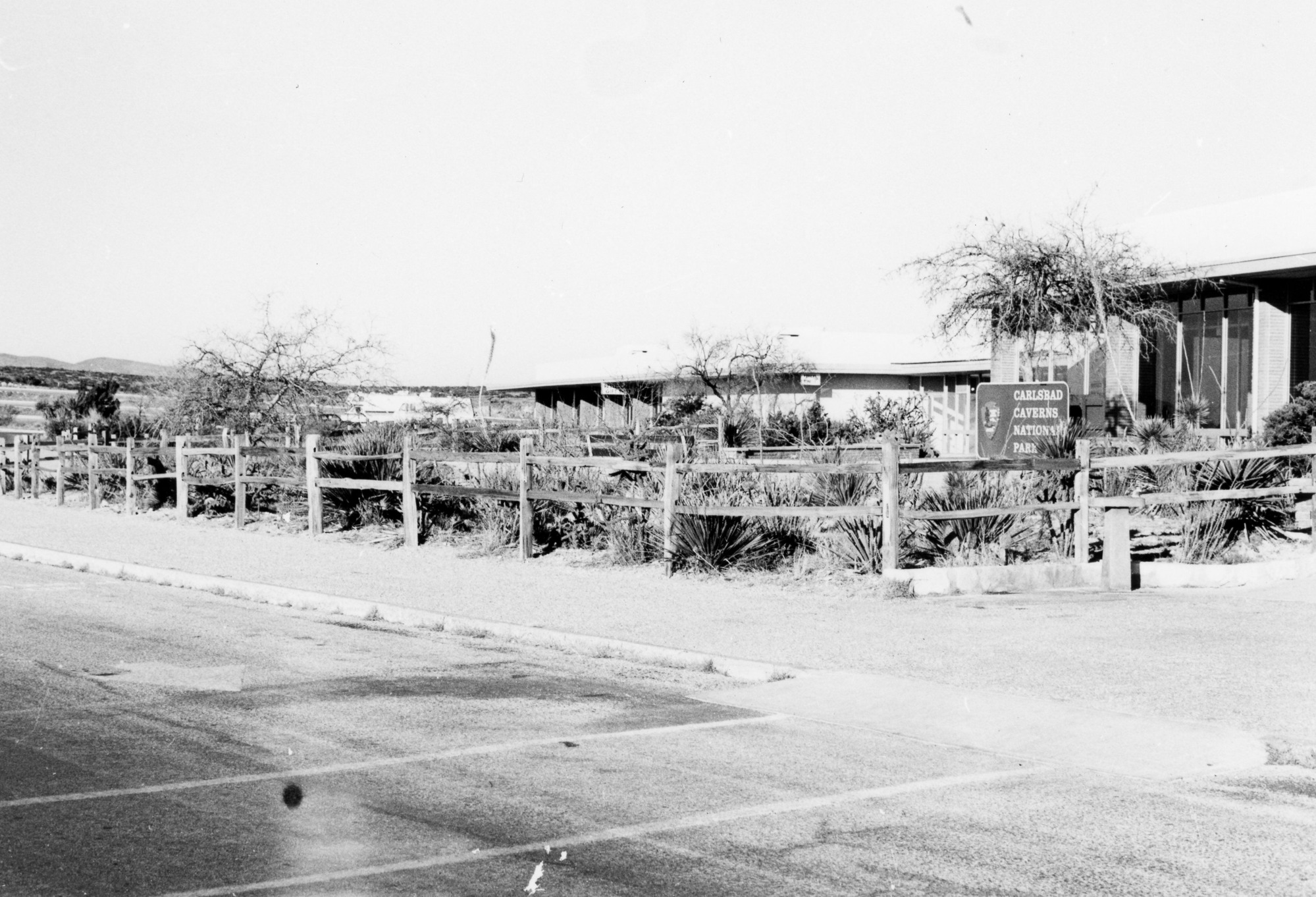 A black and white photograph of the visitor center's front sidewalk.