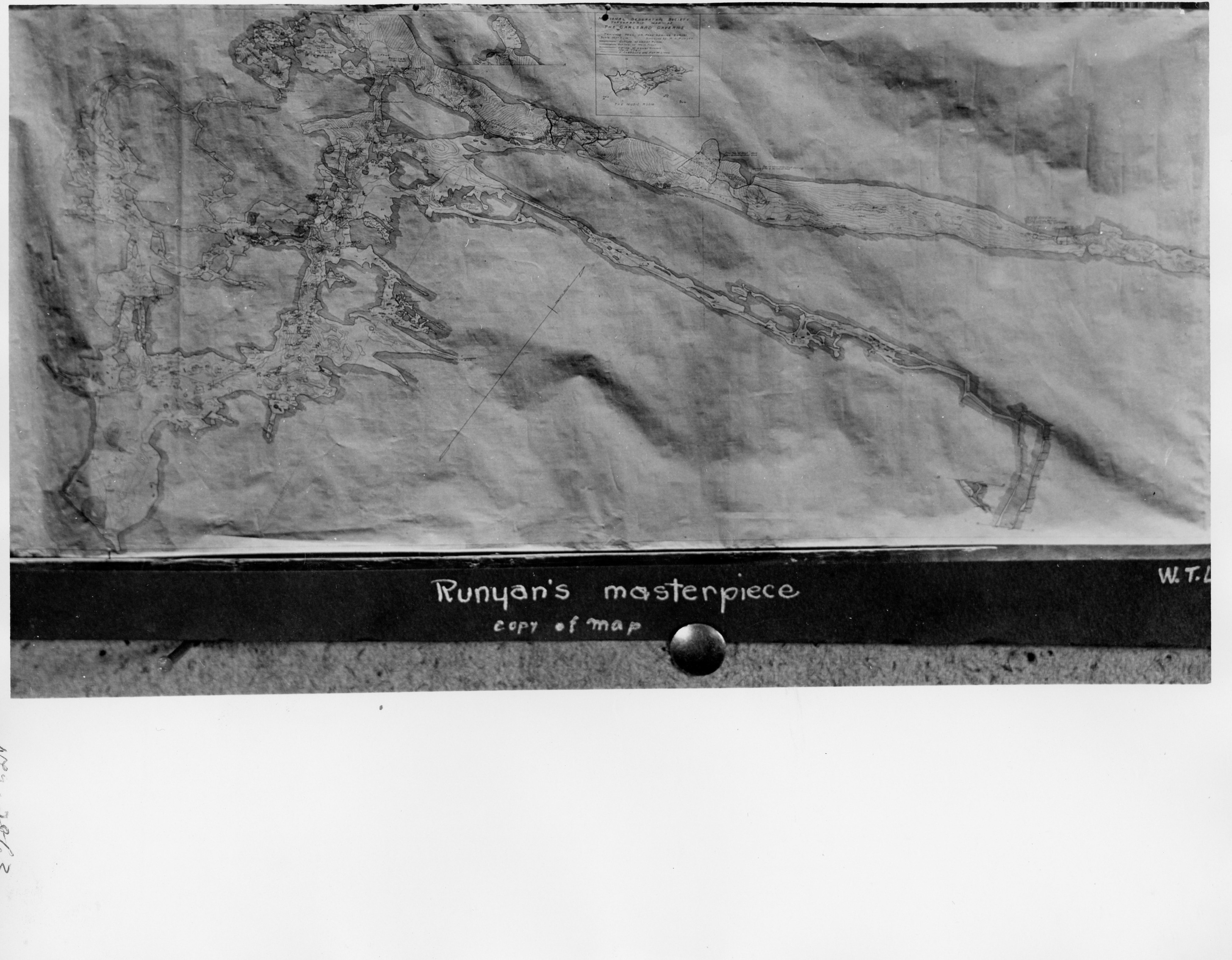 A black and white photograph of "Runyan's Masterpiece" a map of the cavern drawn by Russell Runyan as a result of the National Geographic expedition. The photo seems to show the large scale of the map.