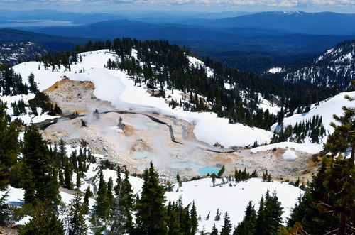 aerial view of a large hydrothermal feature with wooden boardwalk trail through it