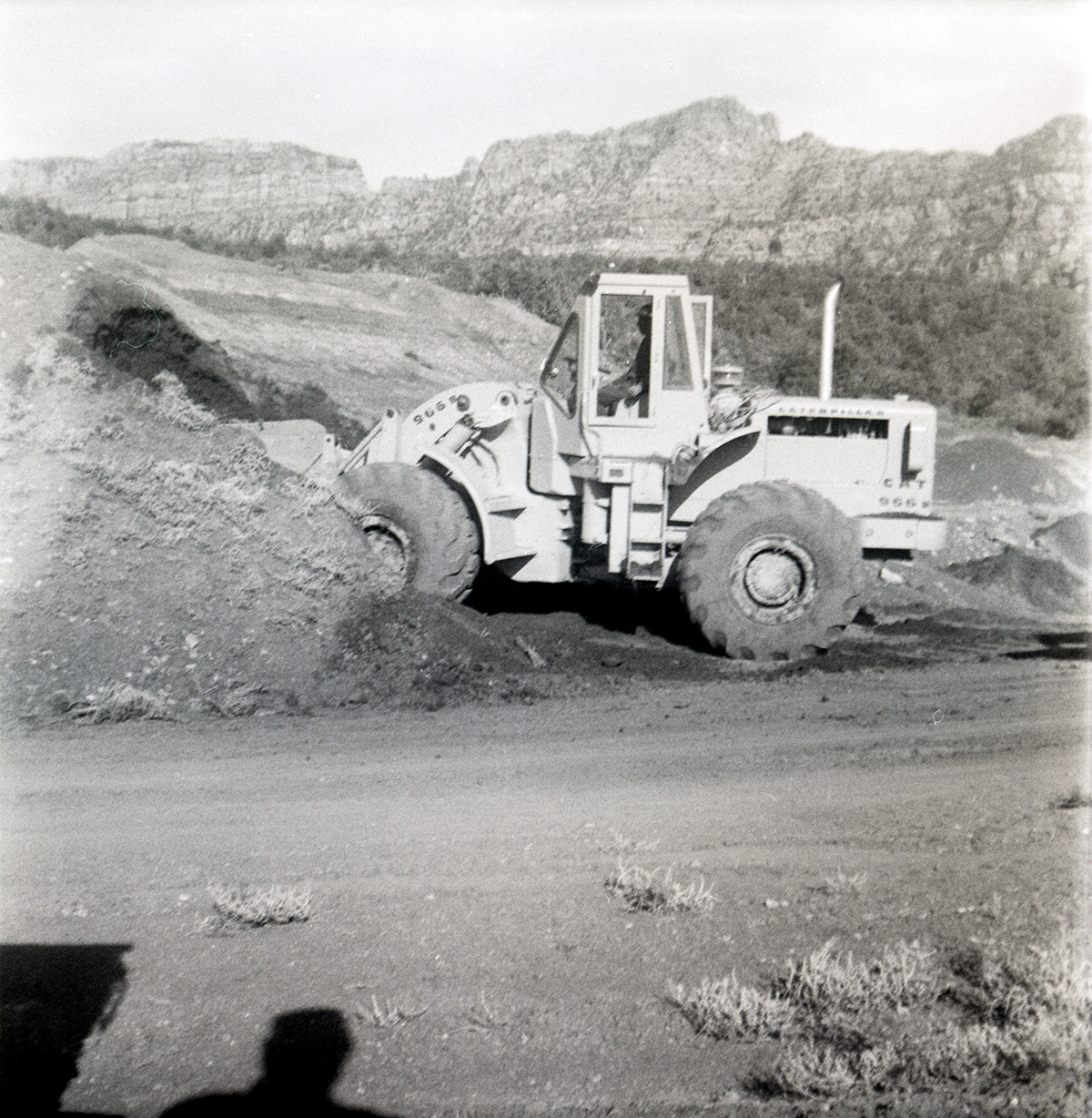 Excavator piling dirt during road grading to Chamberlain Ranch and the Narrows.