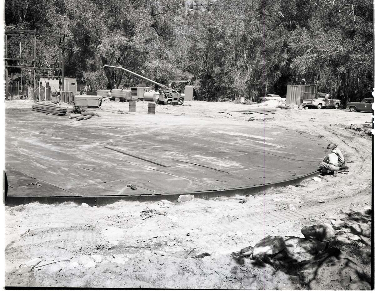 Construction of million gallon water tank at Birch Creek- laying steel plates for floor.