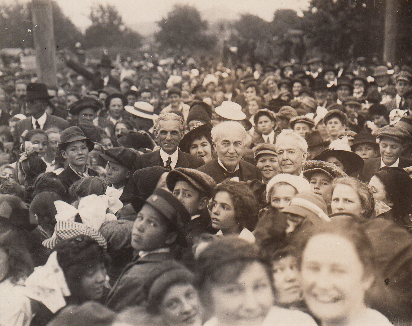 Henry Ford, Thomas Edison, and Luther Burbank surrounded by crowd on California trip.
