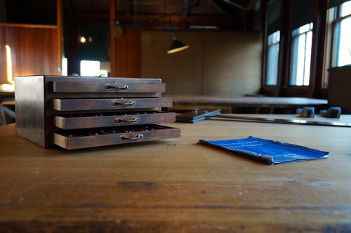 Pencil box and draftsmen's handbook on drafting table