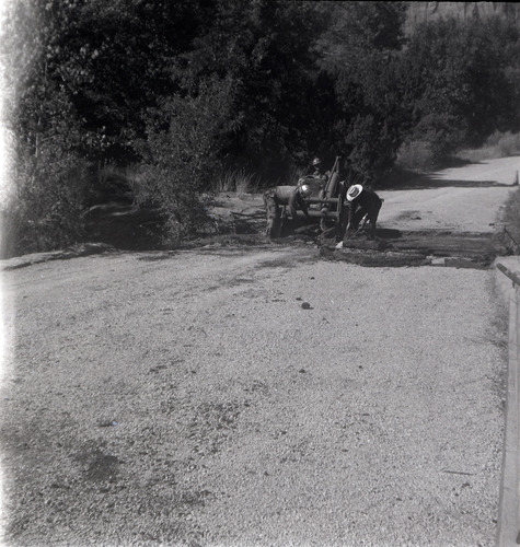Men repairing a section of road along the scenic canyon drive near the Grotto.