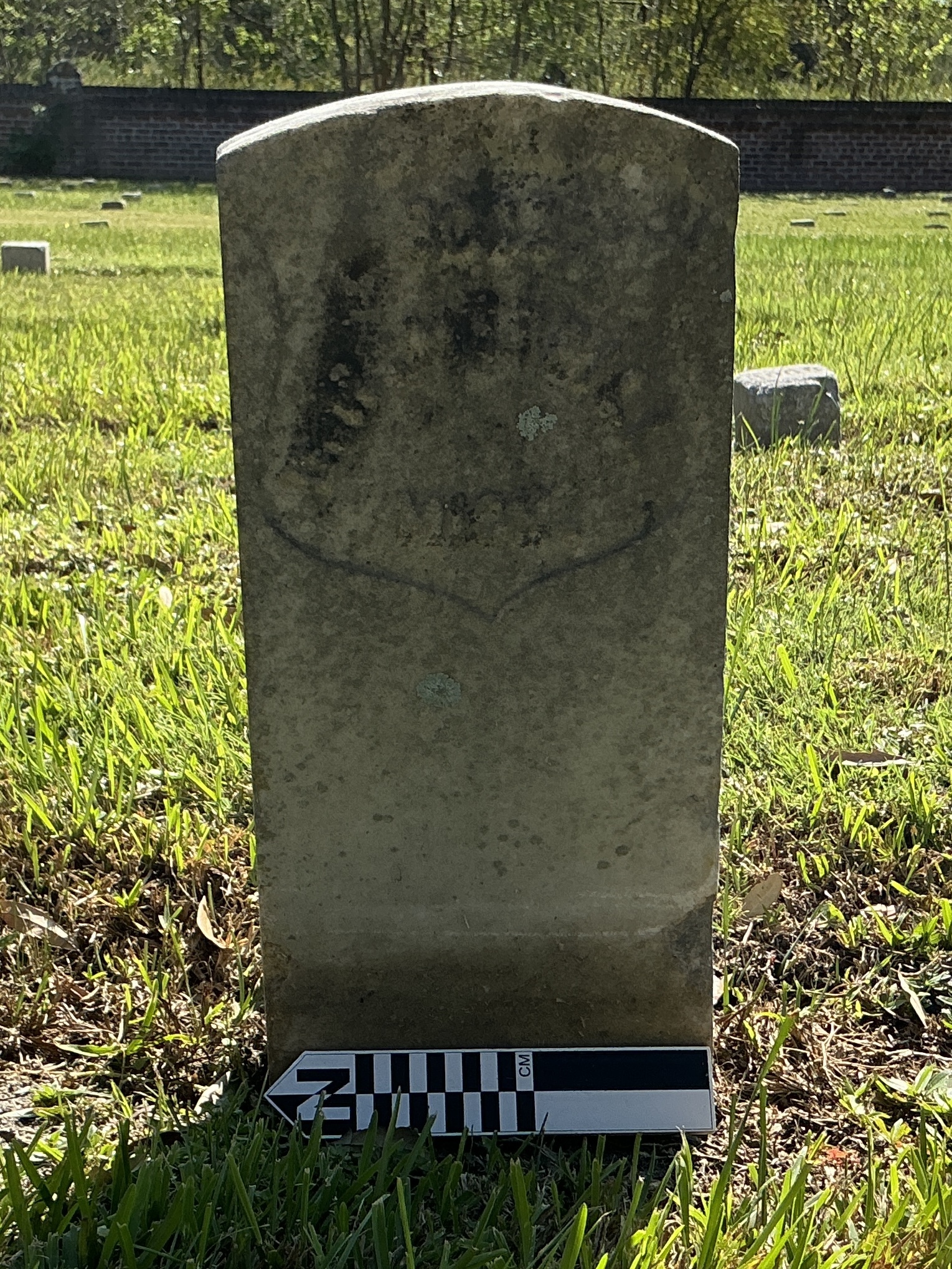 Extra image of historic upright marble headstone with recessed shield face.