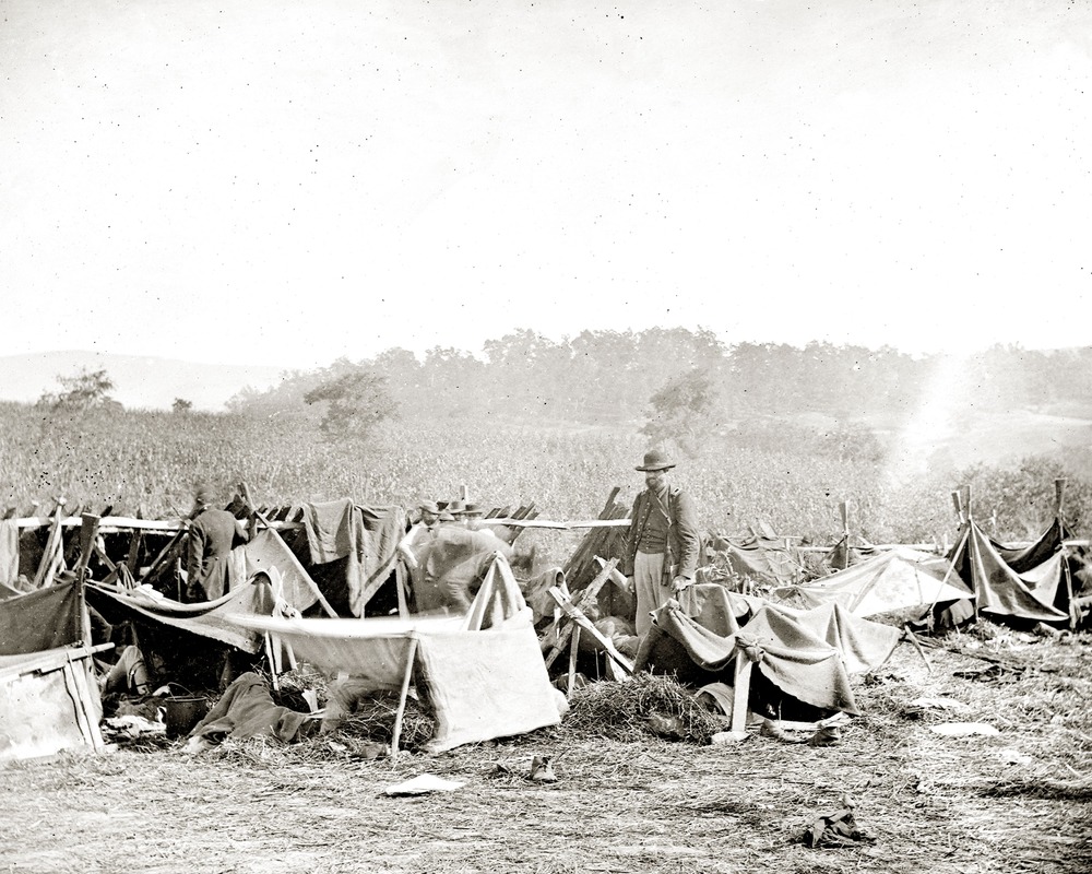 Gardner's title for this image is: Keedysville, Md., vicinity. Confederate wounded at Smith's Barn, with Dr. Anson Hurd, 14th Indiana Volunteers, in attendance