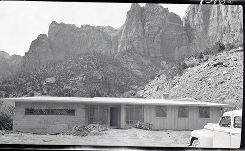 New park residence Building 27 in Oak Creek residential area, front of the house under construction, with piles of debris and a vehicle.