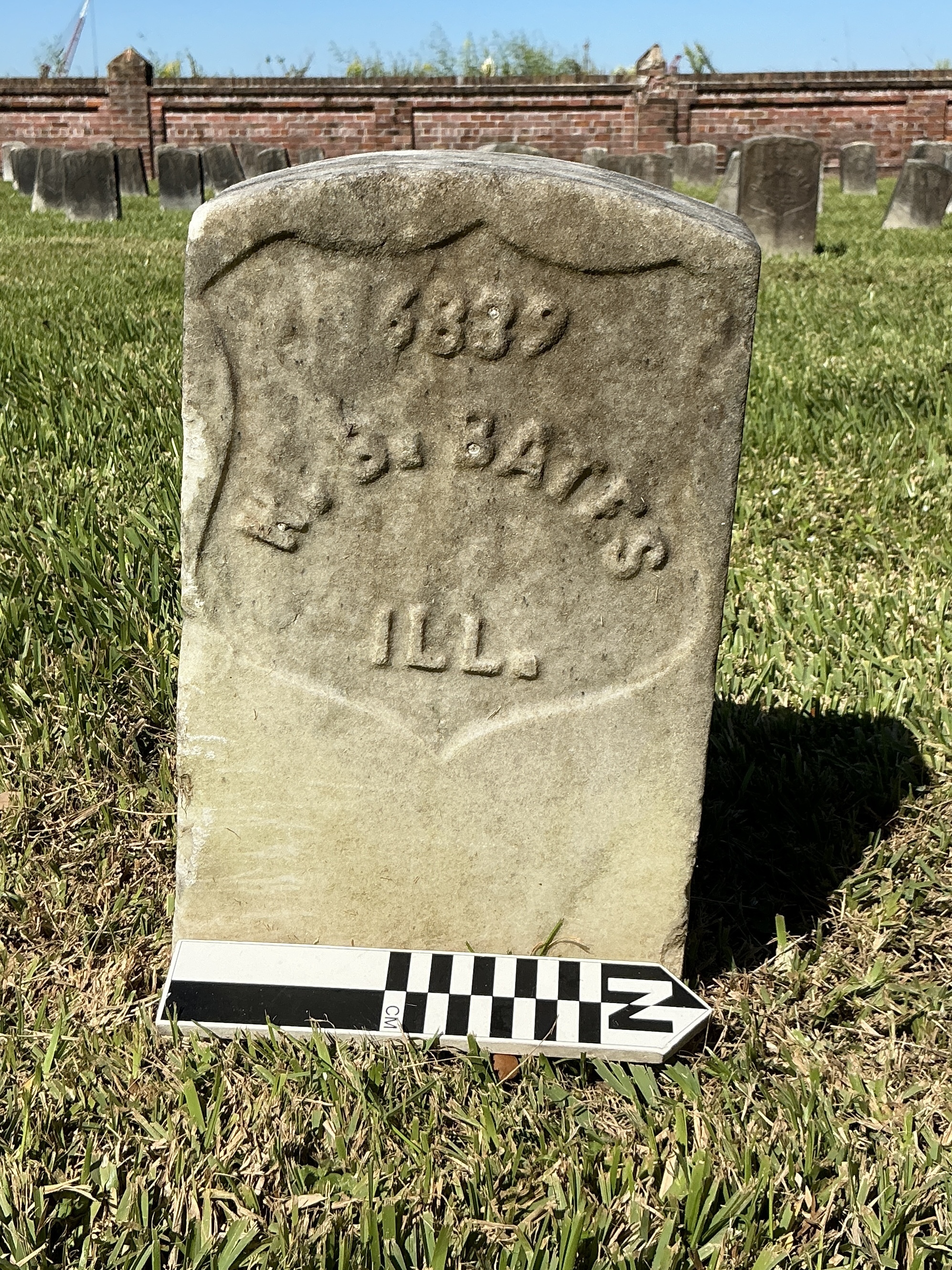 Extra image of historic upright marble headstone with recessed shield face.