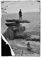 Tourist on Umbrella Rock, Chickamauga & Chattanooga National Military Park, 1864.. Library of Congress Image: tourist standing on Umbrella Rock, 1864, with the Linn Photo Studio. In 1864 when this picture was taken, Royan Linn and his brother J. Birney Linn ran a successful photo studio on the point of Lookout Mountain. Their successful studio captured images of thousands of soldiers and tourists visiting Lookout Mountain. Today, if you stand on the west side of the observatory platform of the Ochs Museum, you are standing near where the Linn Photo Studio building once stood.