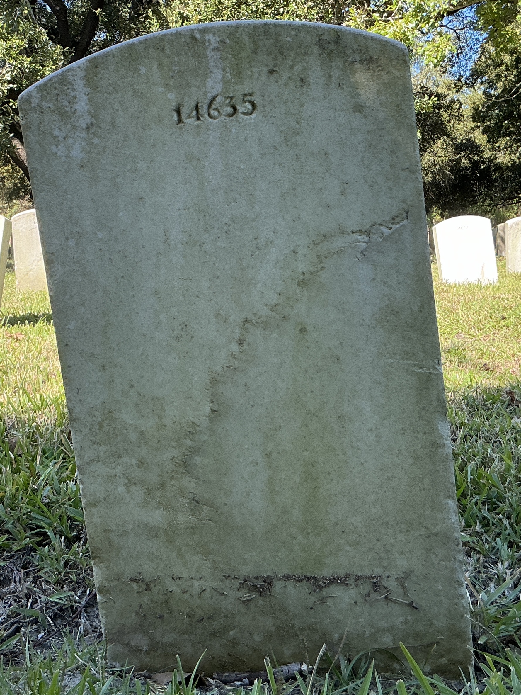 Back of upright marble headstone with flat face.