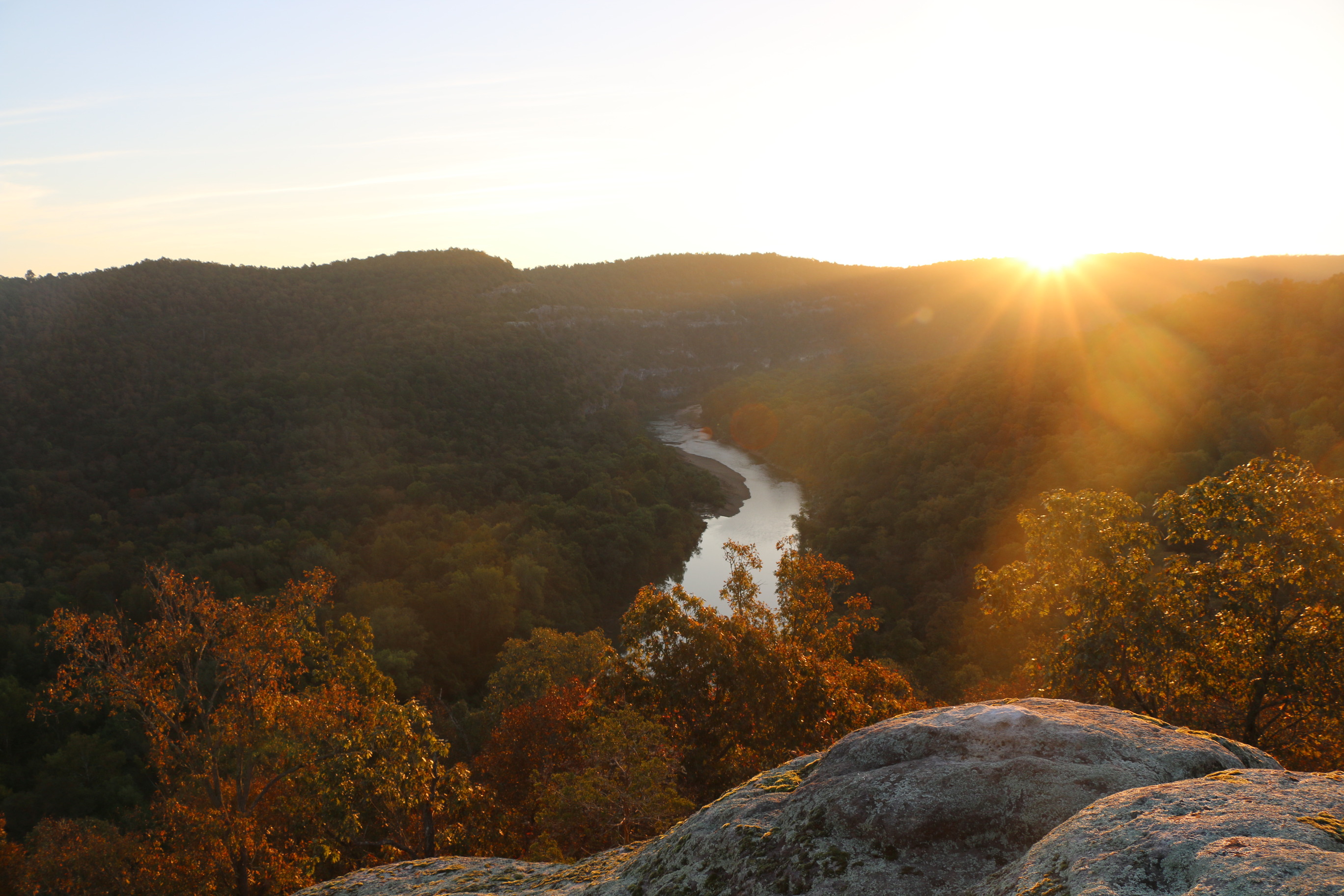 The sun rises over the Lower Buffalo Wilderness, revealing red, orange, and golden leaves