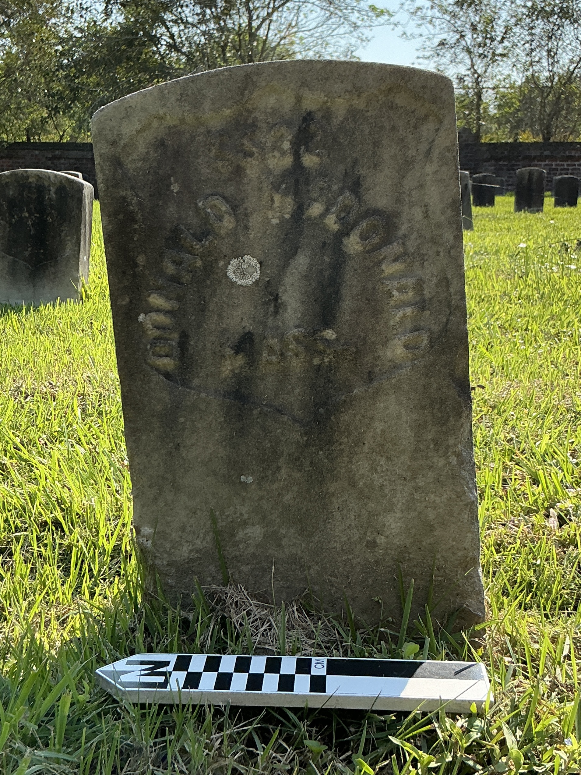 Extra image of historic upright marble headstone with recessed shield face.