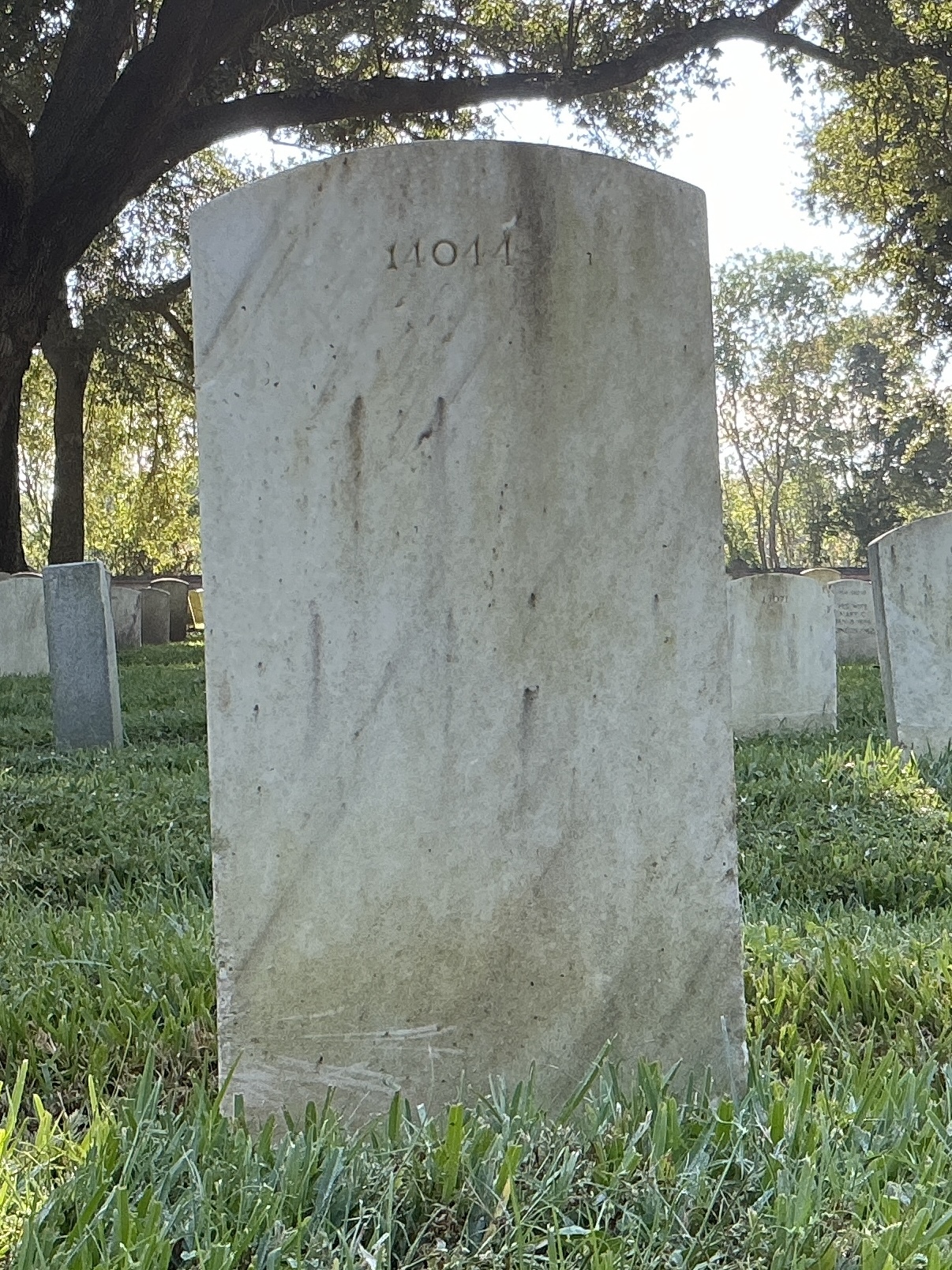 Back of upright marble headstone with flat face.