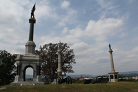 3 monuments and four cannon on top of a hillside