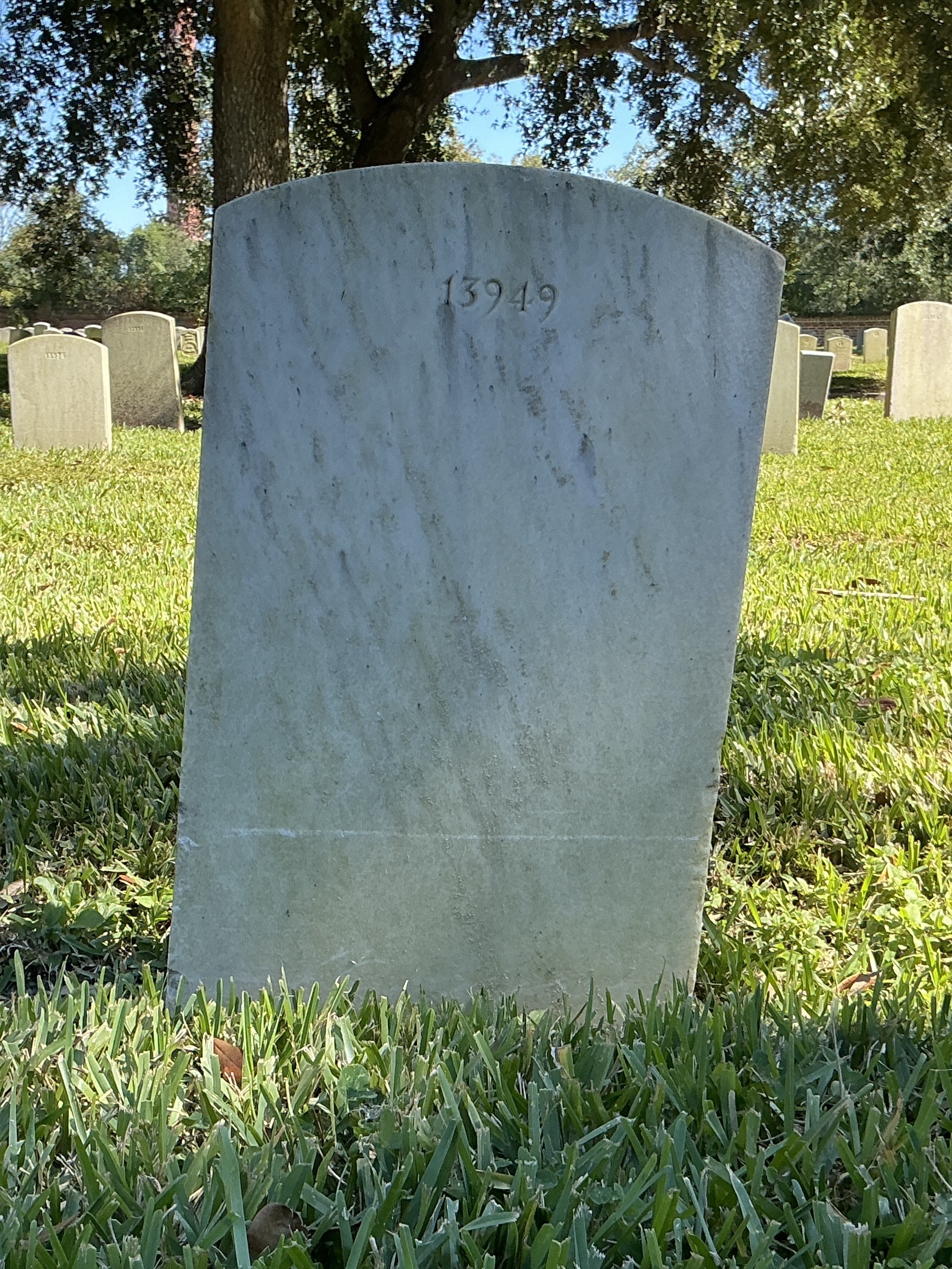 Back of upright marble headstone with flat face.