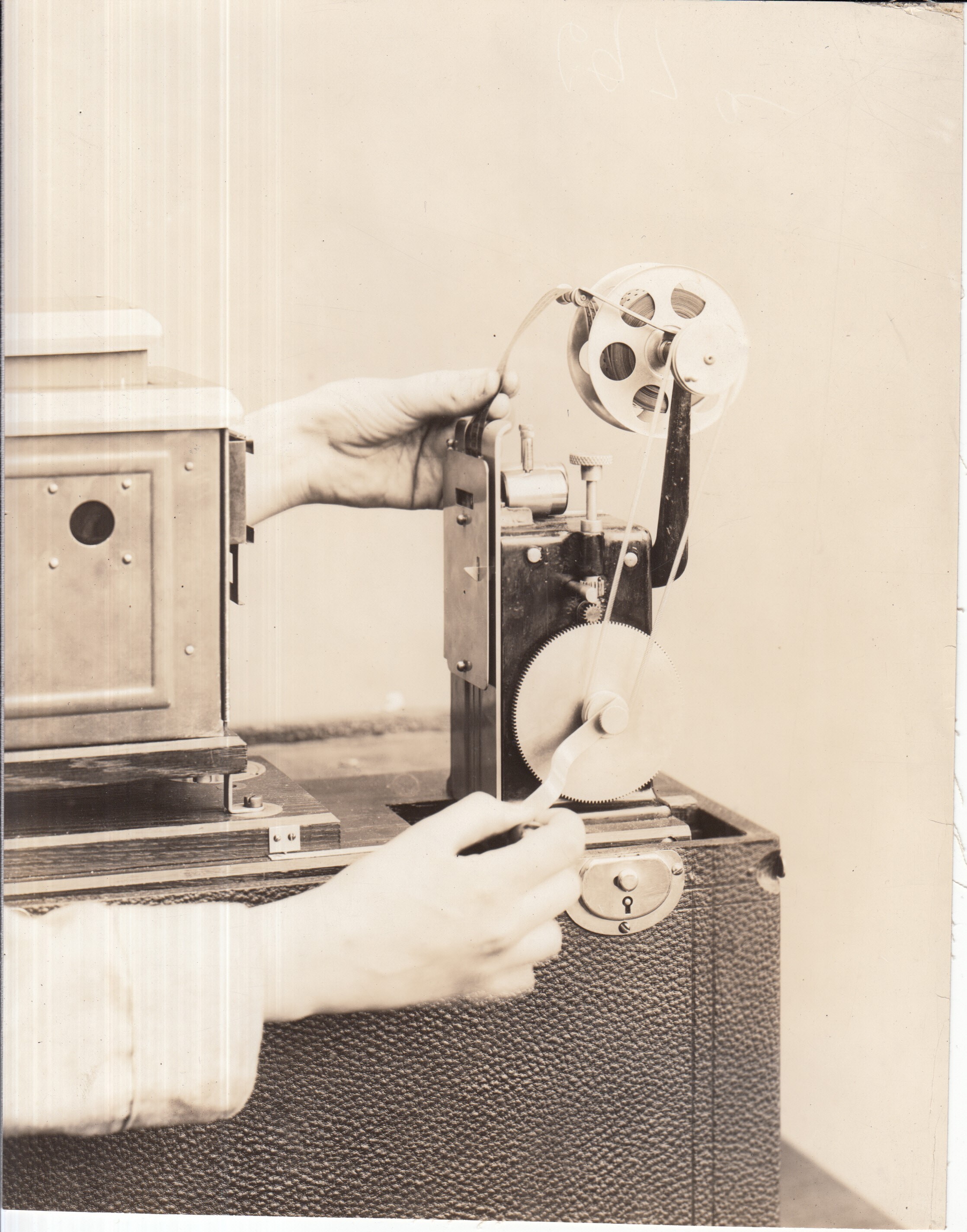 Publicity shot, girl showing lantern slide projector on Edison home projecting kinetoscope.