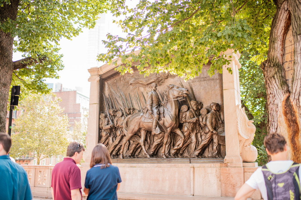 people standing in front of the Robert Gould Shaw Massachusetts 54th Regiment Memorial.