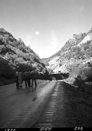 Rock slide, from the west side of the Virgin River about one and a half miles north of park headquarters. May 14, 1941, slide blocked stream and caused the river to destroy a section of the park road, Highway 1. People viewing wash-out. [See catalog numbers ZION 13264 through ZION 13266 for related images.]
