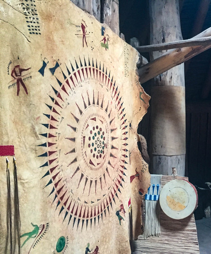 Hanging animal hide decorated with paintings