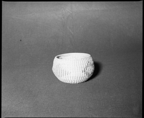 Mrs. Donald Segerstrom Collection. Object: Washoe or Paiute basket. Dimensions: 7 x 4 1/2". Materials: Willow, bracken fern root. Technology: Single rod foundation, non-interlocking stitch, leftward coil direction, design in sunburned willow and bracken fern root. Photographed by Michael Dixon. Catalogued by Craig Bates and Barbara Beroza. Yosemite Collections, National Park Service. 1/83.