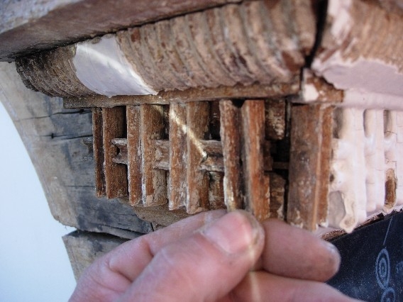 Dormer quarter-round rope mouldings and dentils are carefully cleaned.