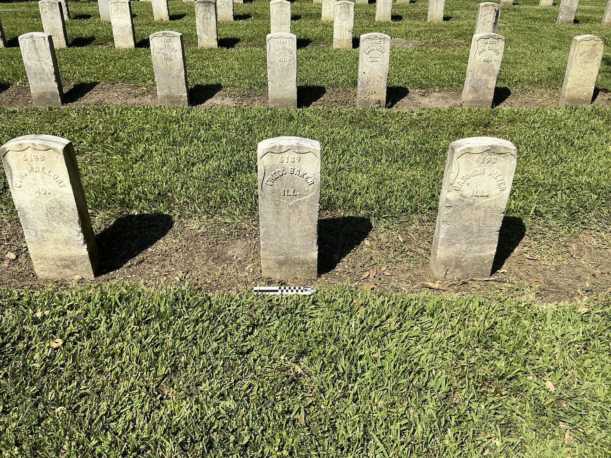 Extra image of historic upright marble headstone with recessed shield face.