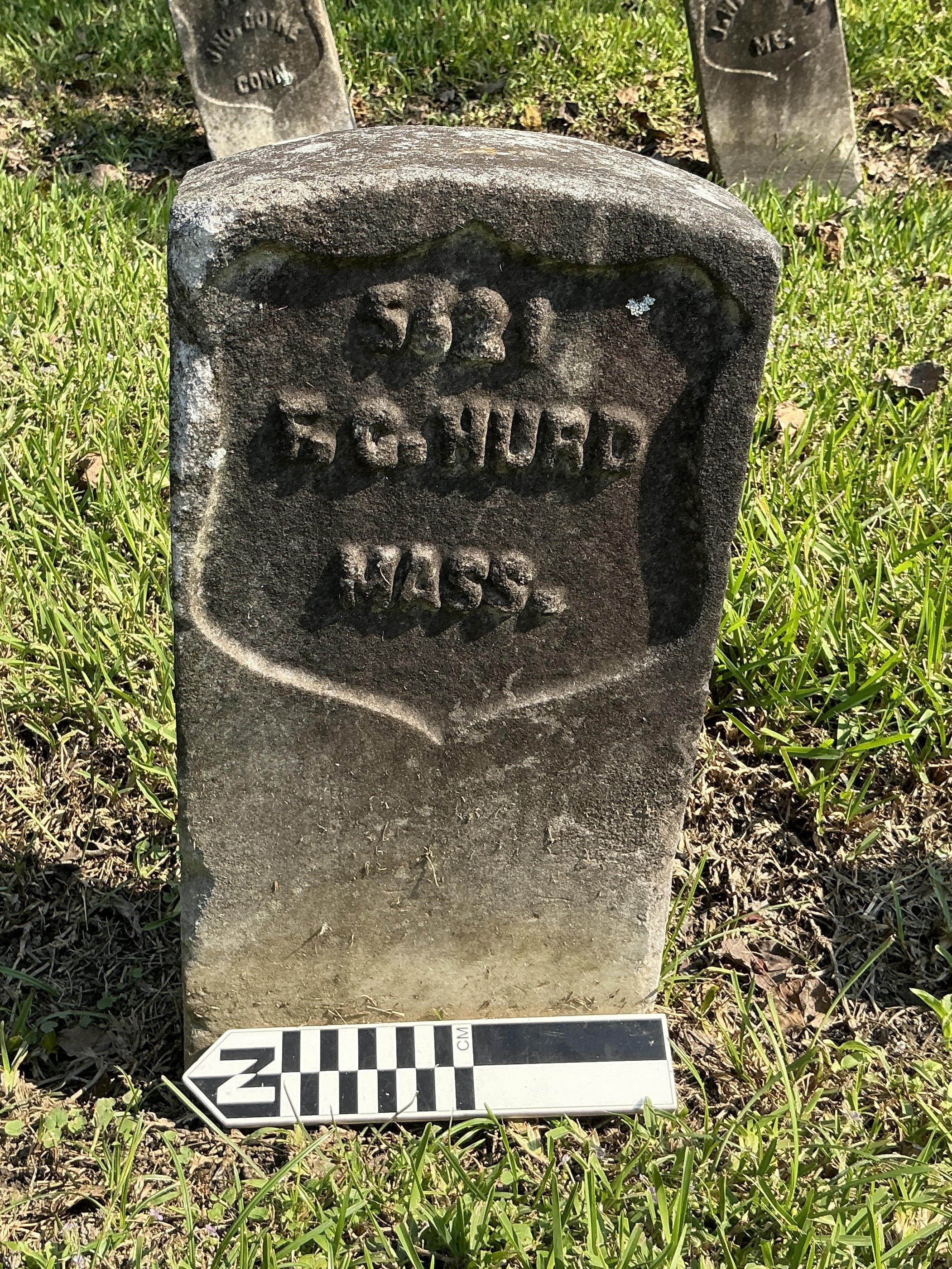 Extra image of historic upright marble headstone with recessed shield face.
