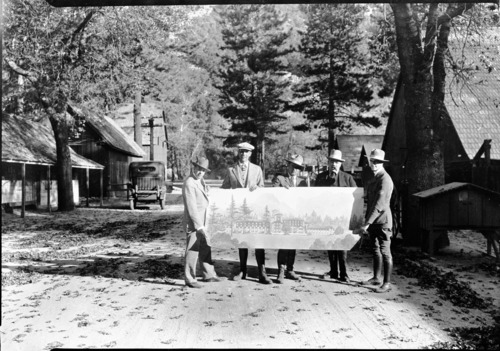 Copy Neg: Leroy Radanovich, 1995. Kennyville street (October 1925). L to R: Messrs. Lewis, Dohrman, Wint, Tressidder, Underwood holding sketch of future Ahwahnee Hotel.