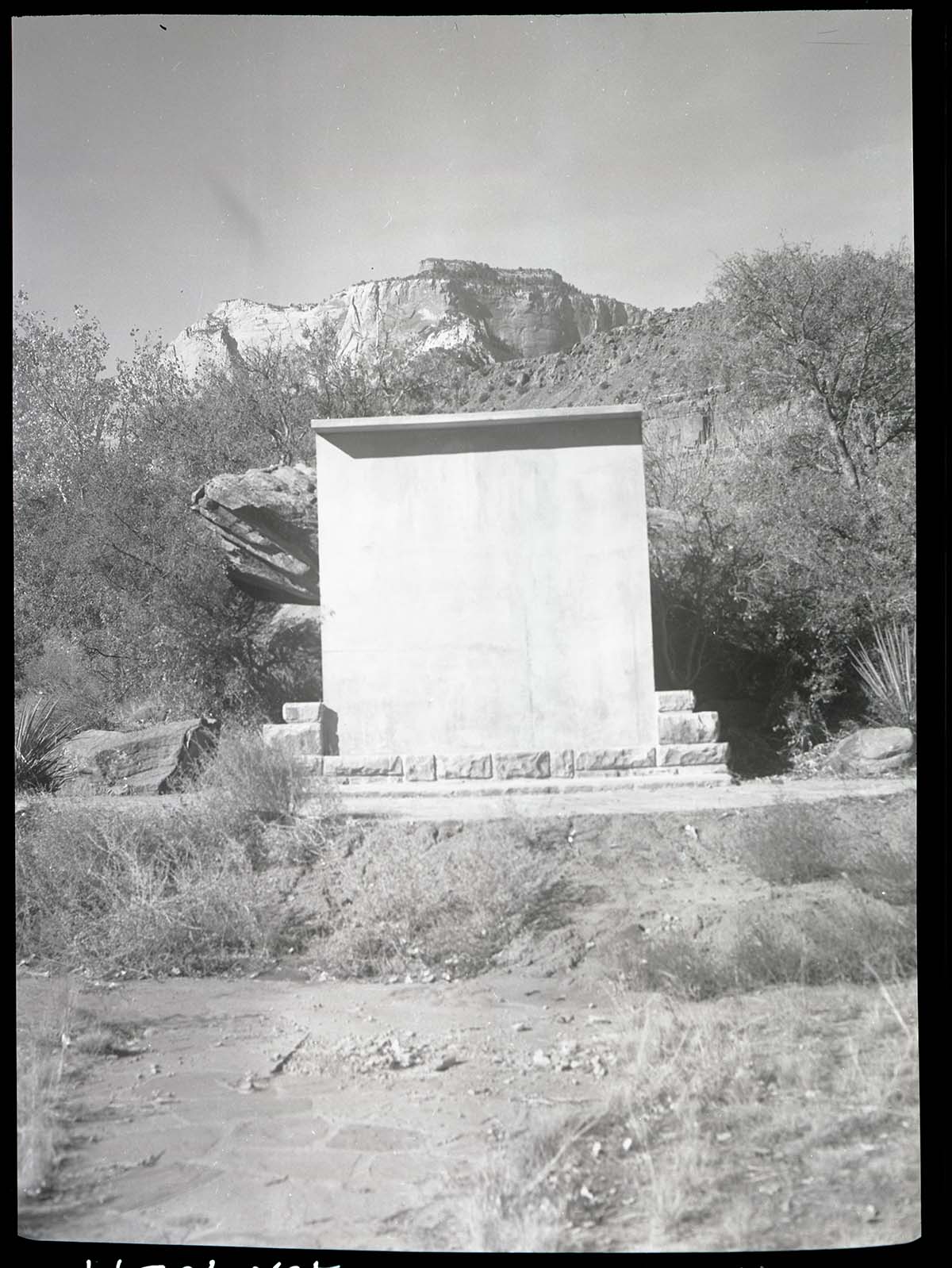 Concrete screen for showing movies and slides in outdoor amphitheater at South Campground lecture circle.
