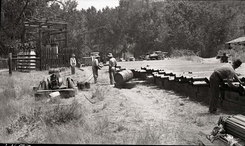 Coating cast iron pipe used in the construction of water line from Birch Creek to Oak Creek alongside park road Highway 1.