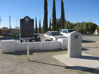 A monument in the middle of a parking lot.