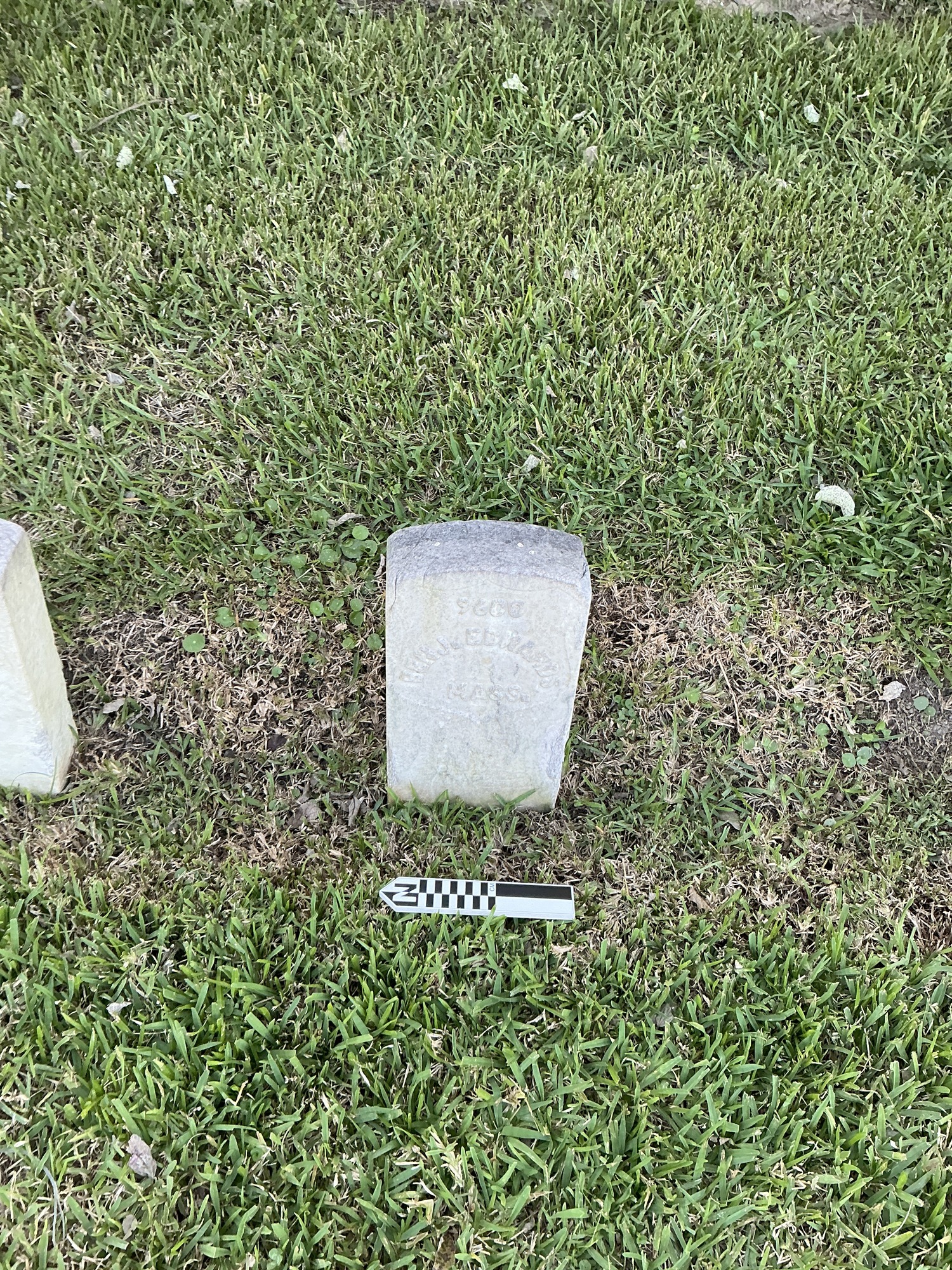 Extra image of historic upright marble headstone with recessed shield face.