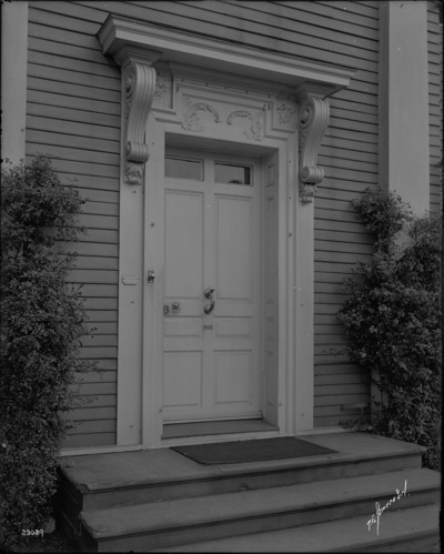 Black and white photograph of ornate front door.