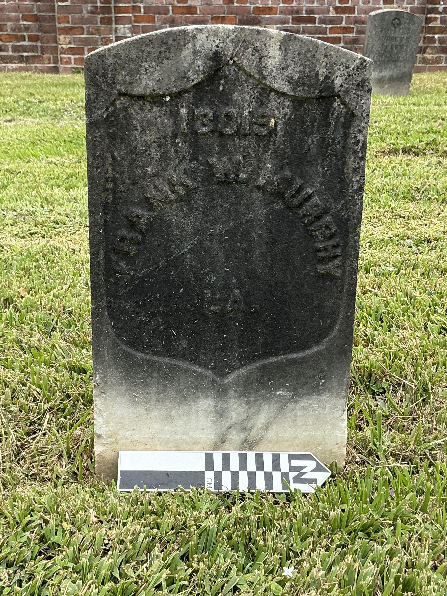 Extra image of historic upright marble headstone with recessed shield face.