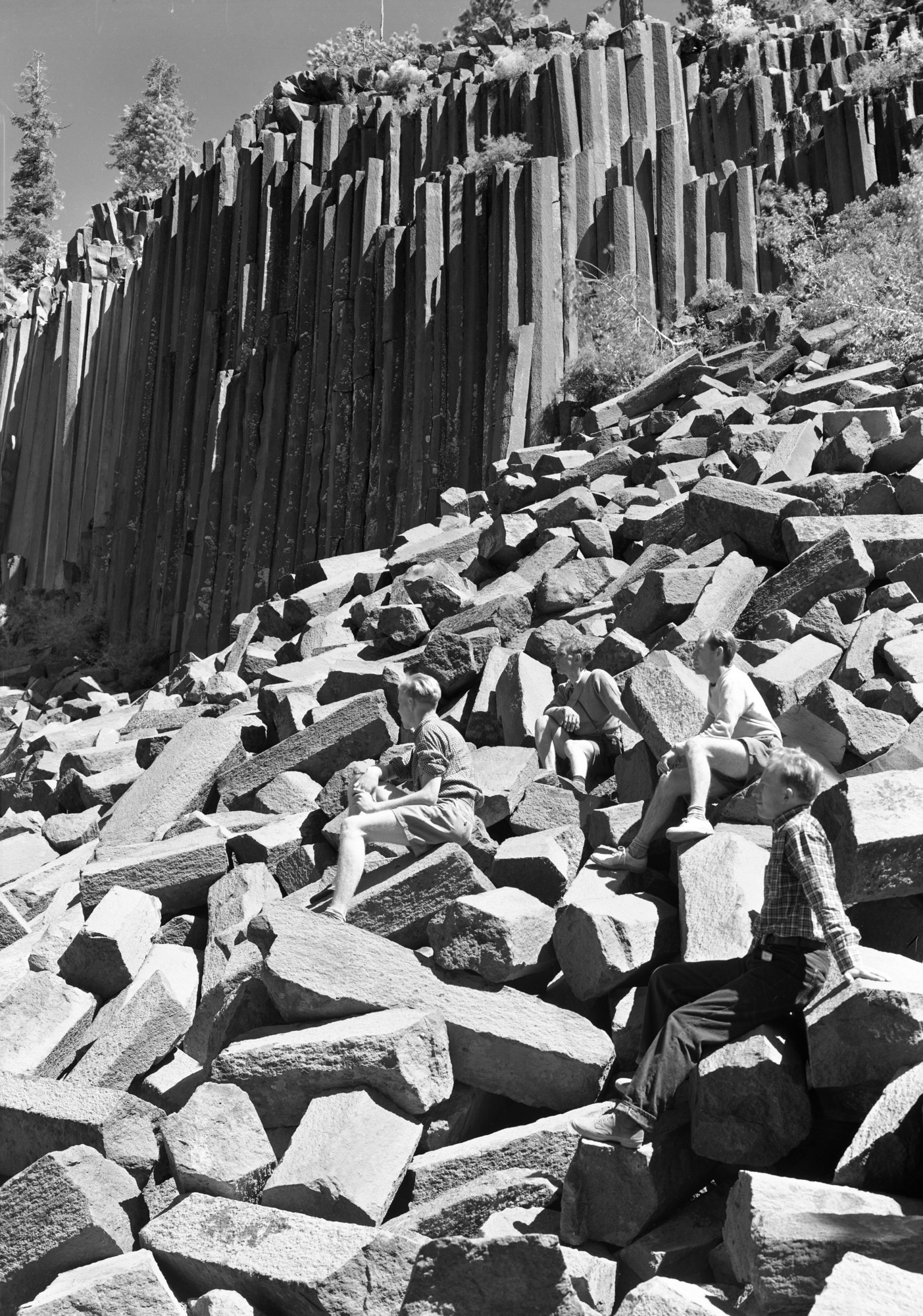 Hikers resting on talus slope of Devil Postpile.
