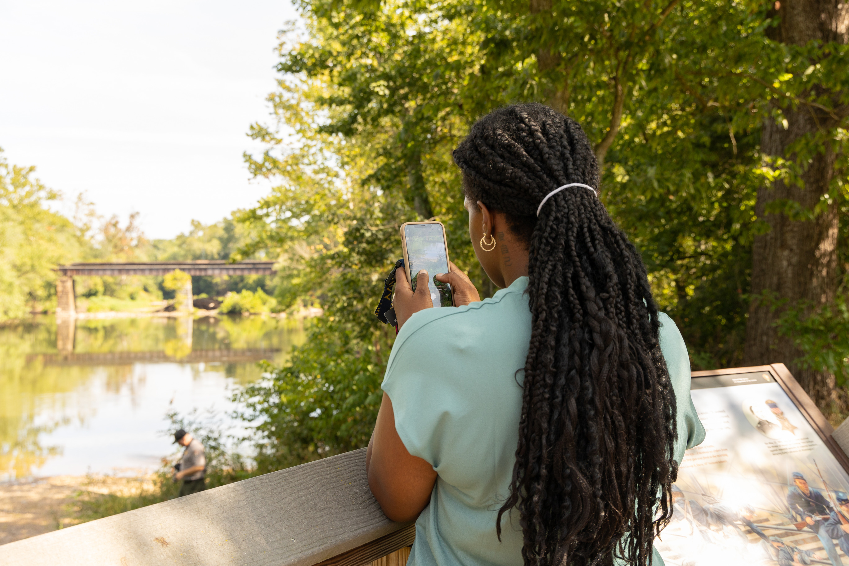 A visitor takes a photo of a Heron while on the Gambrill Trail at Monocacy National Battlefield