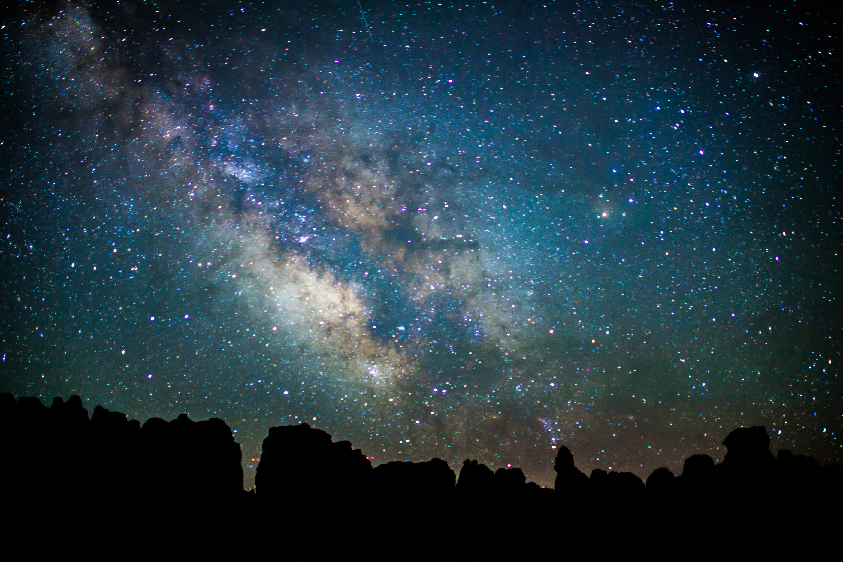 the Milky Way above silhouetted rock pinnacles