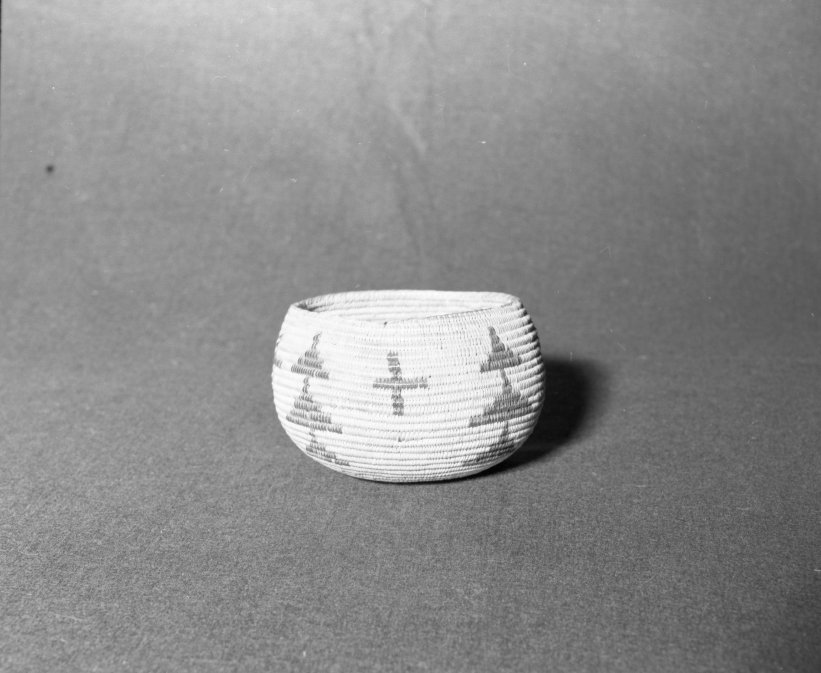 Mrs. Donald Segerstrom Collection. Object: Paiute basket. Dimensions: 6 x 3 1/4". Materials: bracken fern, redbud, sedge root. Technology: non-interlocking stitching, ends trimmed on interior and exterior, overstitched rim. Collection History: . Photographed by Michael Dixon, January 1983. Catalogued by Craig Bates and Barbara Beroza. Yosemite Collections, National Park Service.