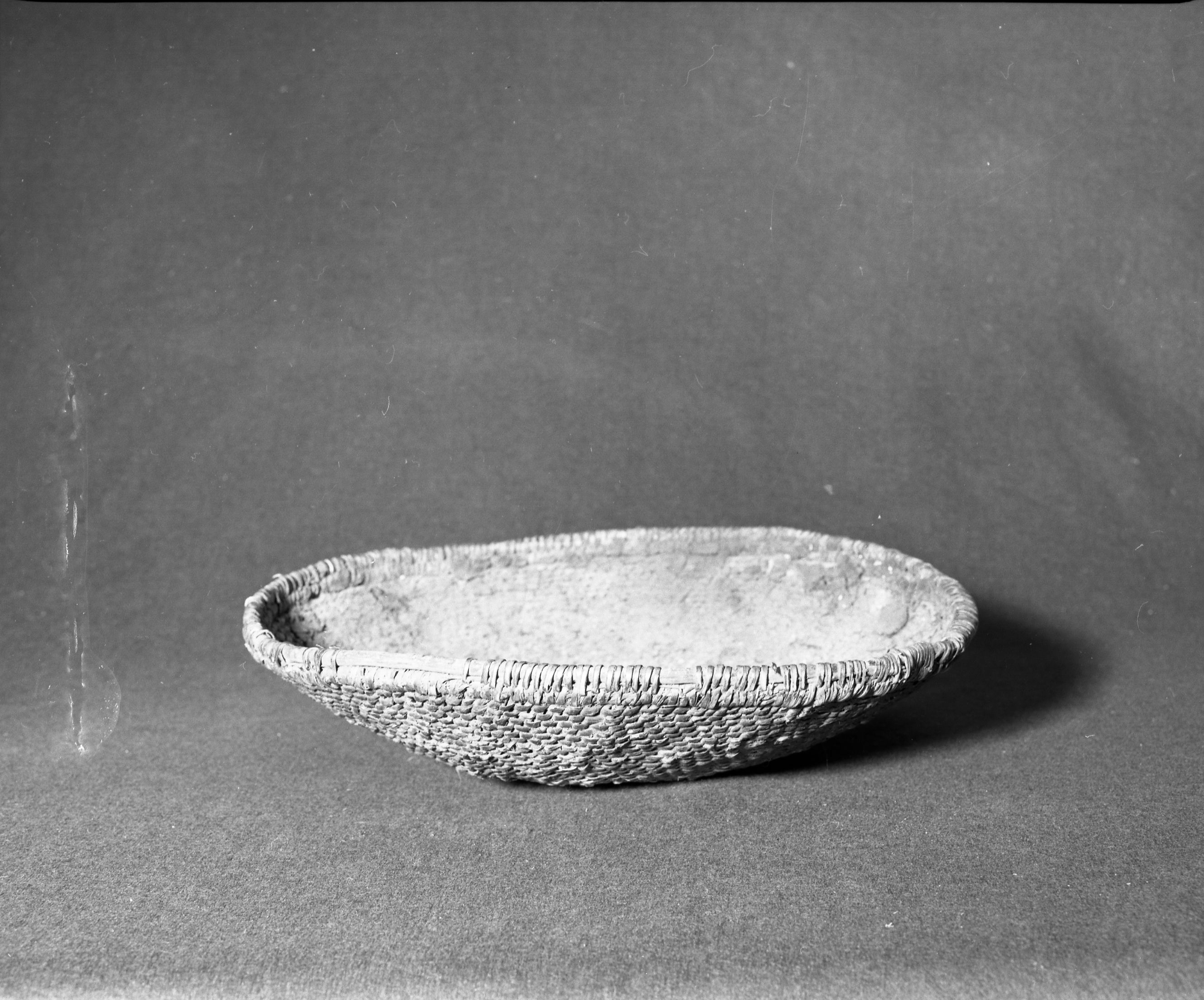 Marie Rozier Collection, Catalog No. 159. Object: Havasupai parching tray. Dimensions: 18 x 4". Materials: split willow, unpeeled willow rods lined with clay. Technology: diagonally twined, up to right slant of turns, bound rim finish. Collection History: Bought by Gail Burak, friend of Mary Long's, in Grand Canyon c. 1950-1960. Photographed by Michael Dixon, December 1982. Catalogued by Craig Bates and Barbara Beroza. Yosemite Collections, National Park Service.