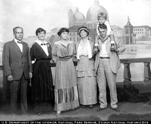 Miller Reese Hutchison (and family?) posing before painted backdrop of Venice. 10.138/14