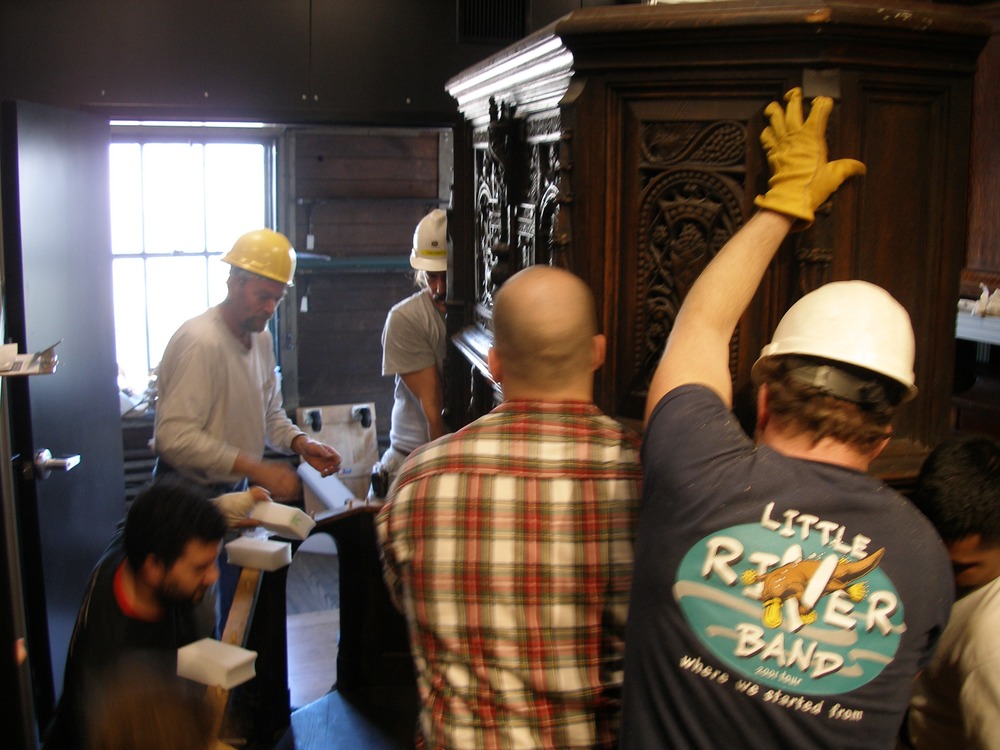 Five workers move the Gothic Phonograph into the new phonograph exhibit.