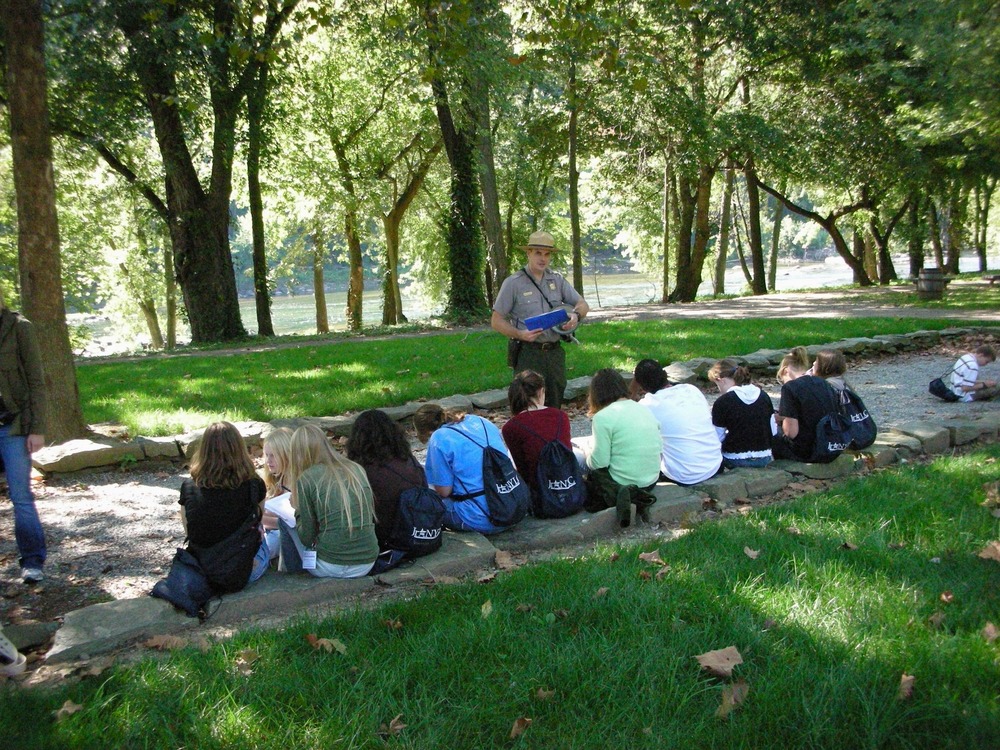 A park ranger presents an education program to a group of students.