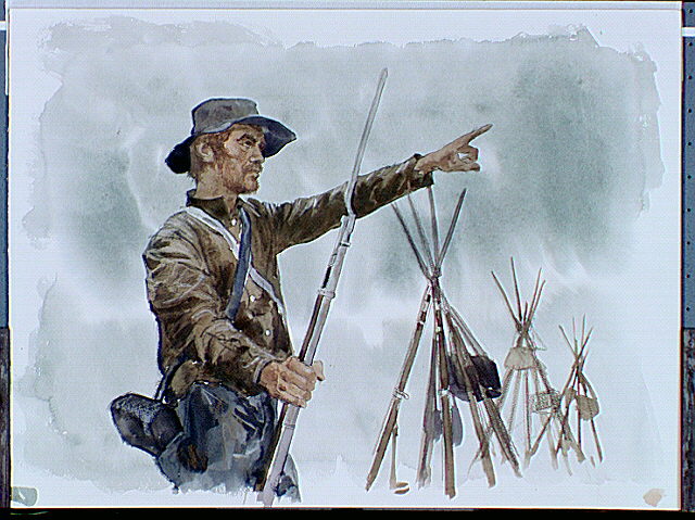 Confederate soldier standing and pointing next to stacked arms.