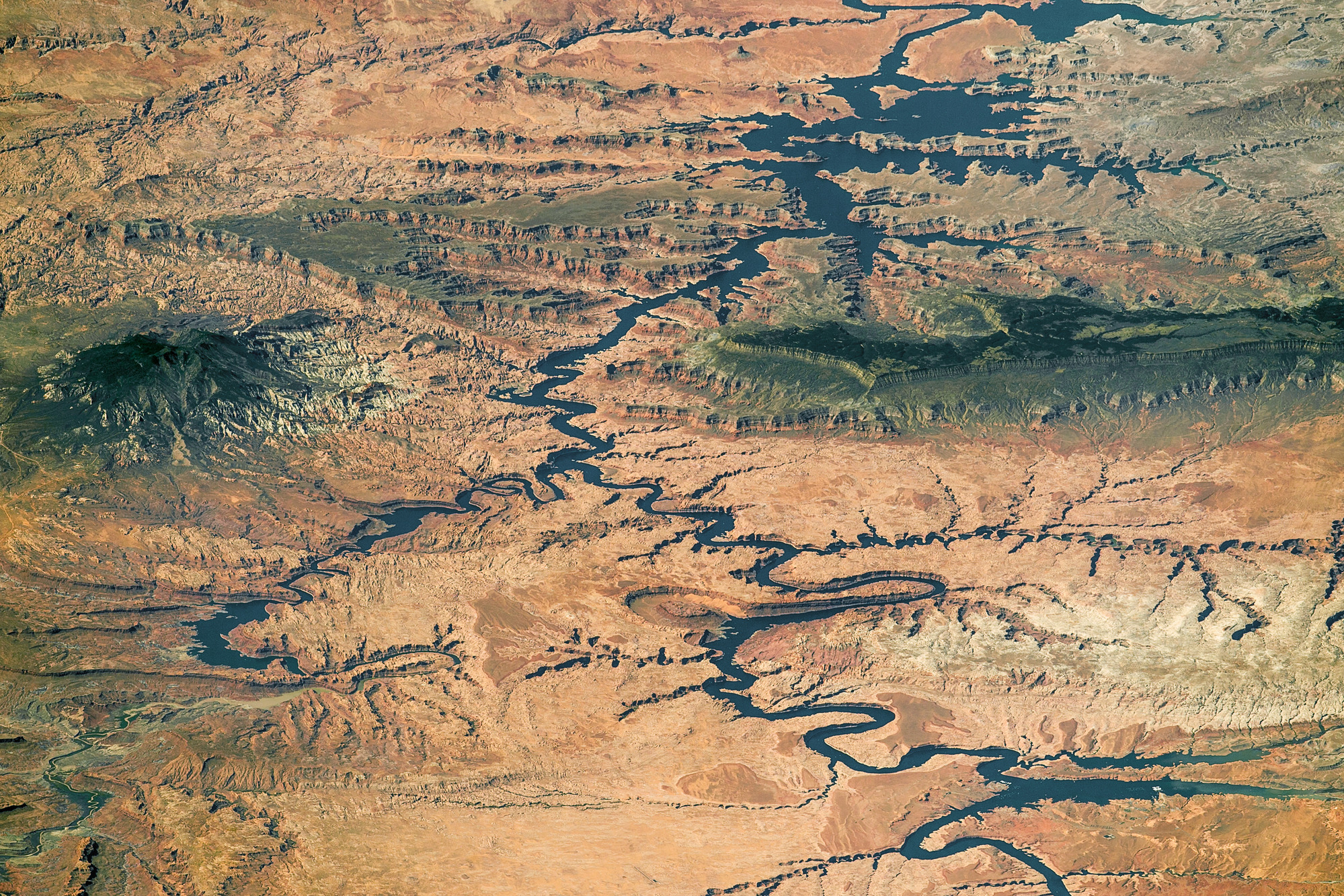 Lake and rivers snaking through a dry canyon- and plateau-dominated landscape appear almost abstract